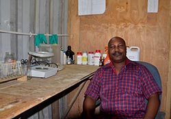Mr. Kawalewale sitting in his inoculant production lab